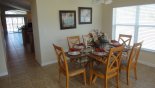 Dining room adjacent to living room with seating for 6 from Beach Palm 1 Villa for rent in Orlando